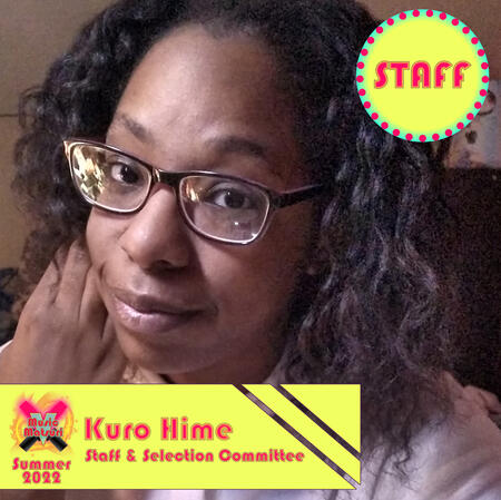 Kuro Hime, a Black person with curly dark brown hair, brown eyes, and wearing glasses.